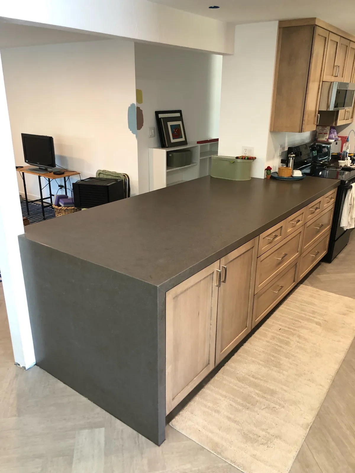 Brown satin quartz countertops with a waterfall end on the peninsula in a renovated Carson City kitchen
